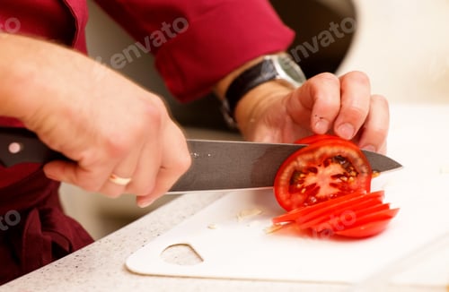 Fresh Red Tomato Being Sliced With Knife