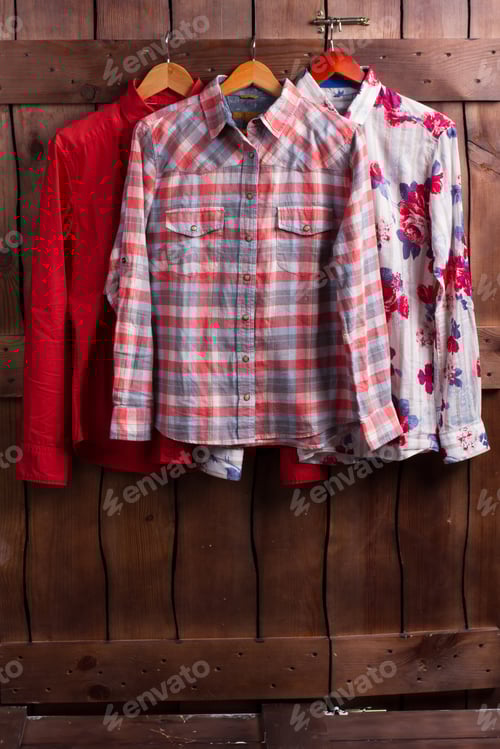 Preview: Shirts Hung on a Wood Paneled Wall