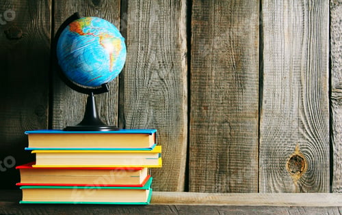Preview: The Globe And Multi-Coloured Books On A Wooden Shelf. On A Wooden Background.
