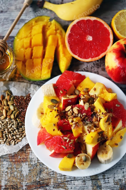 Preview: Fruit Salad On A White Plate. Healthy Salad With Fruits, Honey And Seeds. Healthy Dessert. Proper