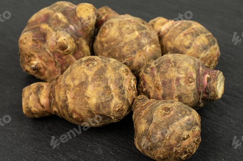 Preview: Group Of Six Whole Fresh Brown Jerusalem Artichoke On Grey Stone