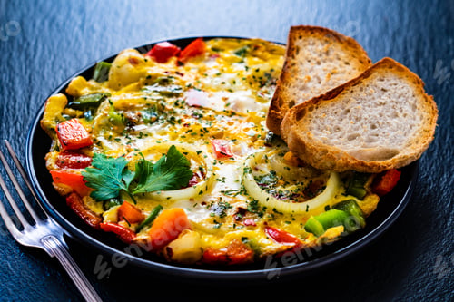 Preview: Breakfast - Scrambled Eggs With Vegetables On Black Stone Background
