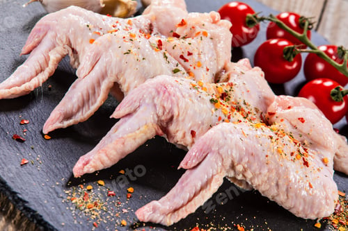 Preview: Raw Chicken Wings On Black Stone On Wooden Background