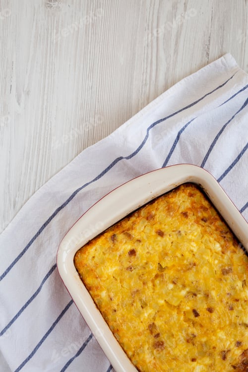 Preview: Homemade Cheesy Amish Breakfast Casserole On A White Wooden Background, Top View. Flat Lay