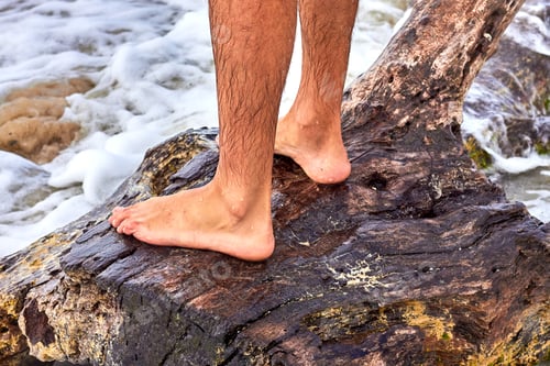 Preview: Legs Of A Man Standing On A Snag On The Seashore