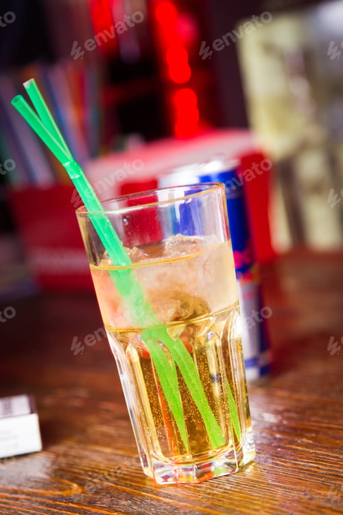 Preview: An Alcoholic Yellow Cocktail Is In Beautiful Glass, On The Bar