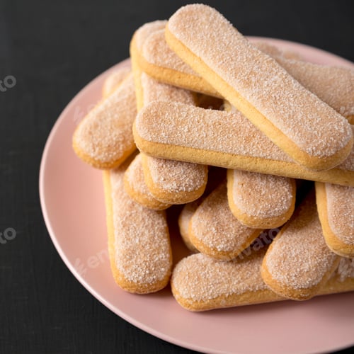 Preview: Savoiardi Or Ladyfingers Cookies On A Pink Plate Over Black Background, Side View. Close-Up.
