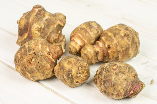 Preview: Group Of Six Whole Fresh Brown Jerusalem Artichoke On White Wood