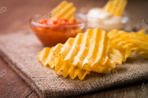Preview: Potato Chips With Mayonnaise And Hot Sauce On Wooden Background