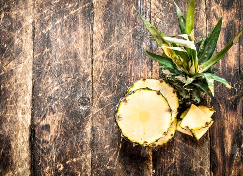Preview: Sliced Fresh Pineapple. On The Wooden Background.