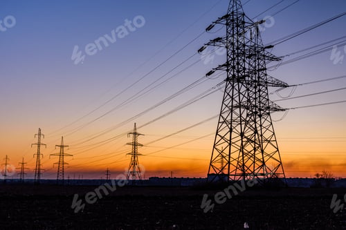 Preview: High Voltage Power Line In Field At Sunset