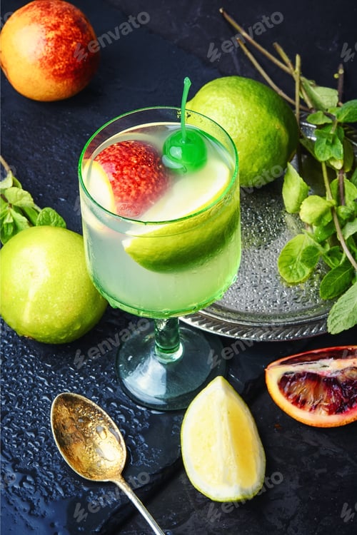 Preview: Summer Cocktail Of Fresh Lime Juice,Orange On Dark Blue Background