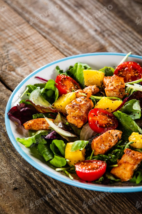 Preview: Salad With Chicken, Mango And Tomatoes On Wooden Table