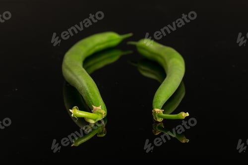 Preview: Group Of Two Whole Fresh Green Bean Isolated On Black Glass