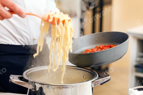 Cooking Fresh Pasta and Tomatoes in a Kitchen