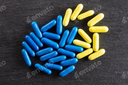 Preview: Lot Of Whole Blue And Yellow Sweet Licorice Comfit Flatlay On Grey Stone