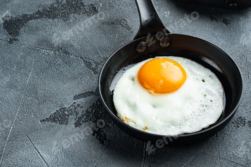 Preview: Fried Eggs With Cherry Tomatoes And Bread For Breakfast In Cast Iron Frying Pan, On Gray Background