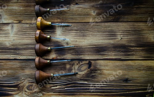 Preview: Set of Gouges Arranged on Wood Surface