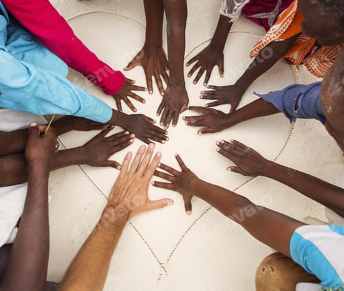 Preview: Hands On Sands Of Black Children From Africa Together With Hand Of A White Man