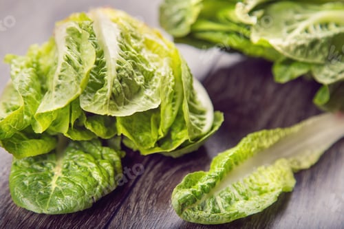 Preview: Few Fresh Leaf Of Raw Ripe Salad Romen On Wooden Background