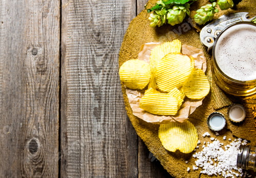 Preview: Beer Rustic Style . Beer And Chips On A Wooden Background.