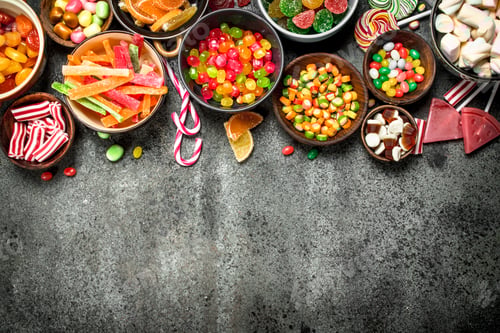 Preview: Multicolored Candy, Jelly And Marshmallows In A Bowl. On A Rustic Background.