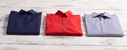 Preview: Folded Shirts on a White Wooden Background