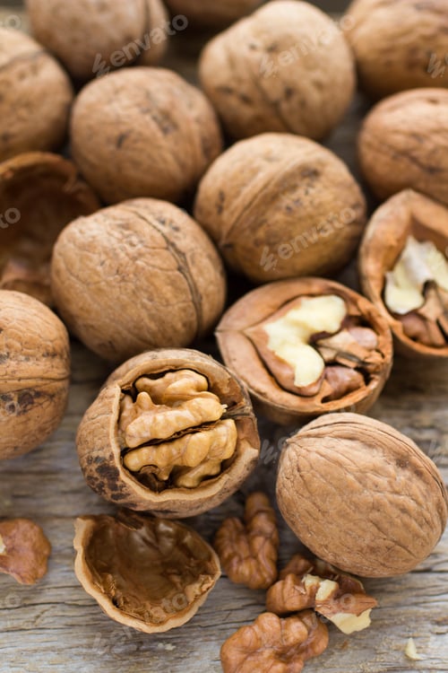 Preview: Walnut Kernels And Whole Walnuts On Rustic Old Wooden Table. Soft Focus
