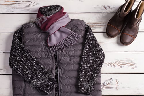 Preview: Stylish Warm Men'S Clothing. Knitted Sweater And Vest On A Wooden Background.