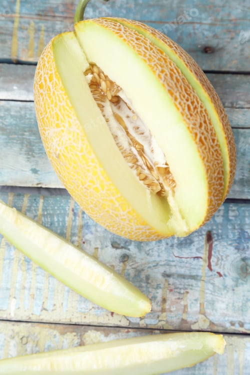 Preview: One Cut Fresh Ripe Melon On A Wooden Background