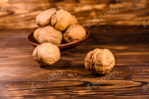 Preview: Ceramic Plate With Walnuts On Rustic Wooden Table