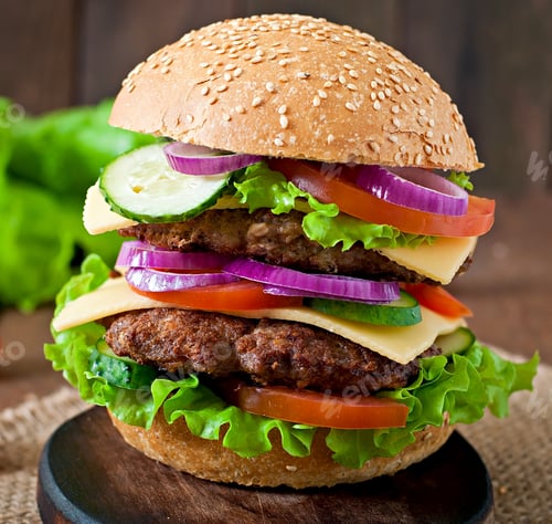 Preview: Big Juicy Hamburger With Vegetables And Beef On A Wooden Background In Rustic Style