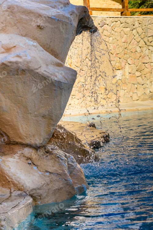 Preview: Small Waterfall With Turquoise Water In Hotel Pool