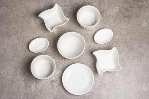 Preview: Assorted White Empty Bowls And Plates On A Stone Background. Different Ceramic Dishes And Kitchen