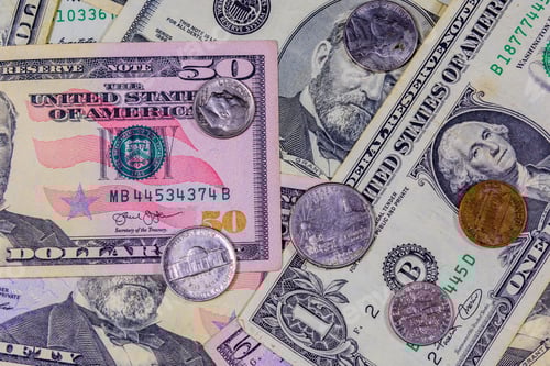 Preview: Different American Cent Coins Over Dollar Banknotes