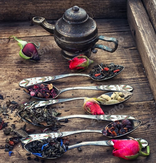 Preview: Varieties Of Tea Brewed In An Iron Spoon On The Background Of Symbolic Teapot