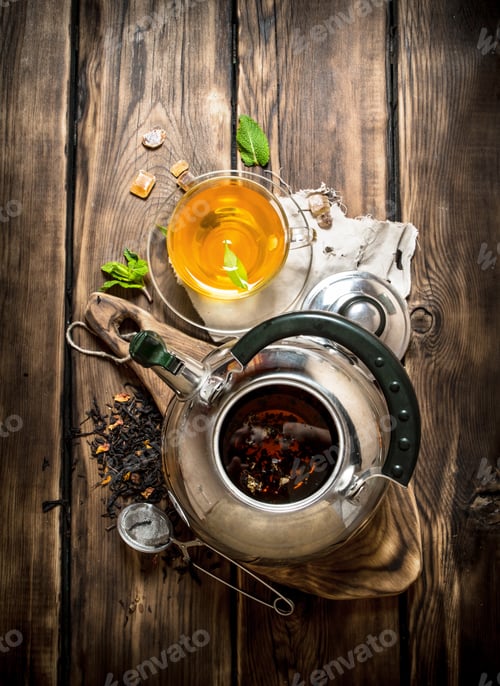 Preview: Kettle With Fragrant Floral Tea. On Wooden Background.