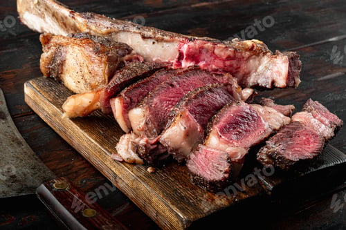 Preview: Grilled Steak On The Bone Sliced, Medium Rare Tomahawk Cut Set, On Wooden Serving Board, On Old