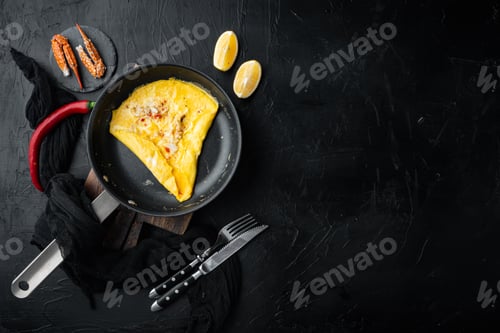 Aperçu: Chilli Crab Silky Omlette, On Frying Iron Pan, On Black Background, Top View Flat Lay , With