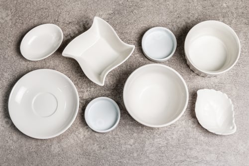 Preview: Assorted White Empty Bowls And Plates On A Stone Background. Different Ceramic Dishes And Kitchen