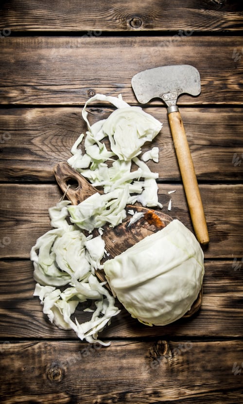 Preview: Hopped Cabbage With An Old Hatchet . On Wooden Background.