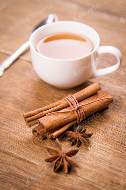 Preview: Fresh Tea In White Cup With Cinnamon And Anis In Studio