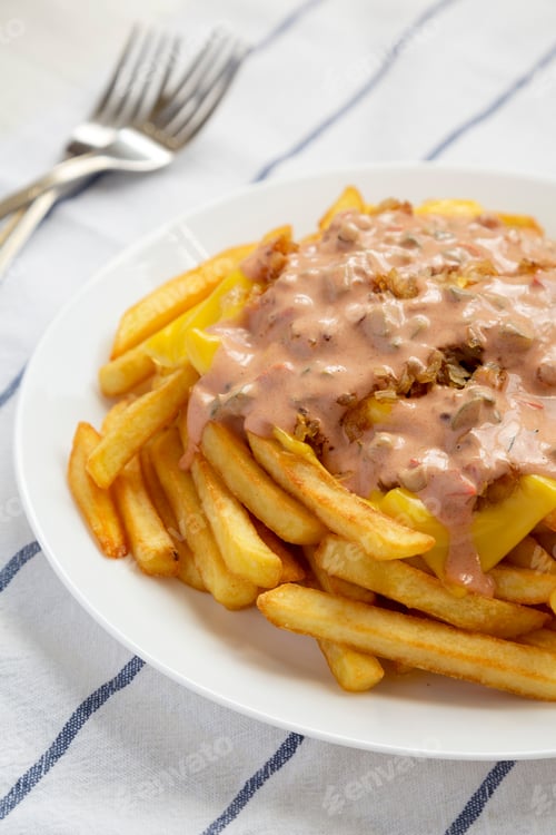 Preview: Homemade Animal Style French Fries On A White Plate, Low Angle View.