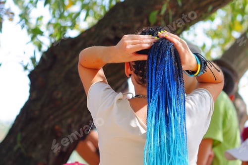 Preview: Girl With Blue Dreadlocks Straightens Her Hair. Back View