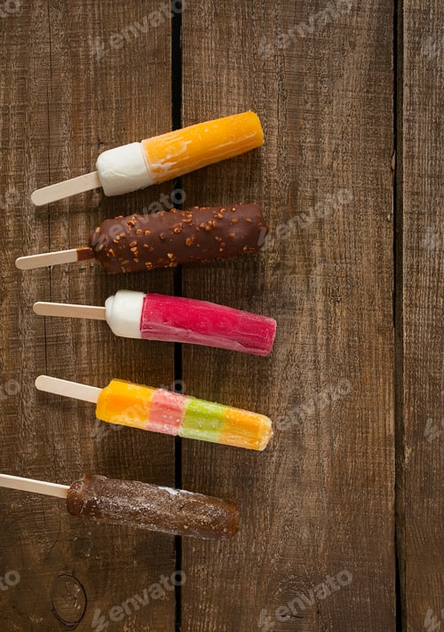 Preview: Various Ice Cream Popsicles On Wooden Surface