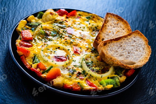 Preview: Breakfast - Scrambled Eggs With Vegetables On Black Stone Background