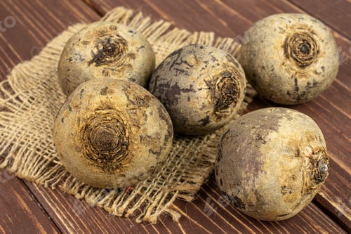 Preview: Group Of Five Whole Raw Red Beetroot On Natural Sackcloth On Brown Wood