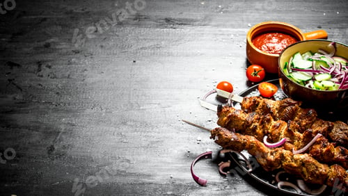 Preview: Shish Kebab Of Pork And Salad. On The Black Wooden Table.