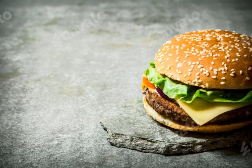 Preview: Fresh Burger With Cheese And Meat On A Stone Stand. On The Stone Table.