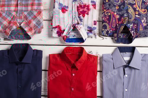 Preview: Many Various Bright Modern Men'S Shirts With Different Colors And Prints On Old Wooden Store Shelf.